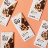 Multiple coffee toffee bars on coral background