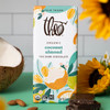 Coconut Almond Bar on counter next to unwrapped chocolate squares and coconut and almonds