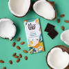Coconut Almond bar next to open coconuts and almonds on colorful background