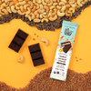 Theo Chocolate Cashew Caramel Crunch 70% Filled Dark Chocolate  with ingredients on yellow background