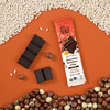 Theo Chocolate Hazelnut Crisp 70% Filled Dark Chocolate with ingredients on orange background