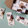 Open milk chocolate lover gift box with with treats on blue background